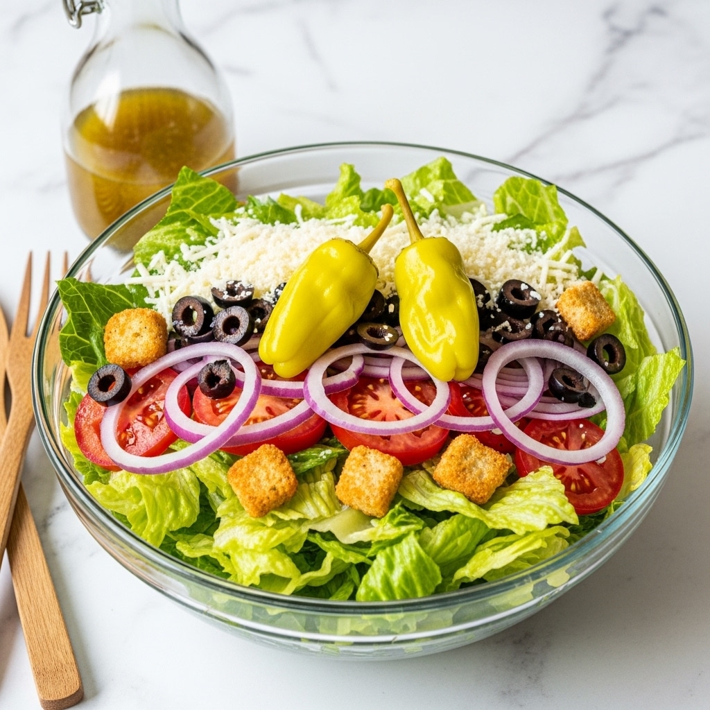 A clear glass bowl filled with a fresh salad sits on a white marbled surface. The salad has three main layers: a base of light green lettuce leaves, a middle layer of bright red tomato slices and yellow pepperoncini peppers, and a top layer with crunchy golden brown croutons, dark black olives, and thin slices of purple onion. The salad is lightly sprinkled with shredded white cheese, adding a soft texture on top of the colorful vegetables. Photo taken with an iphone --ar 4:5 --v 7