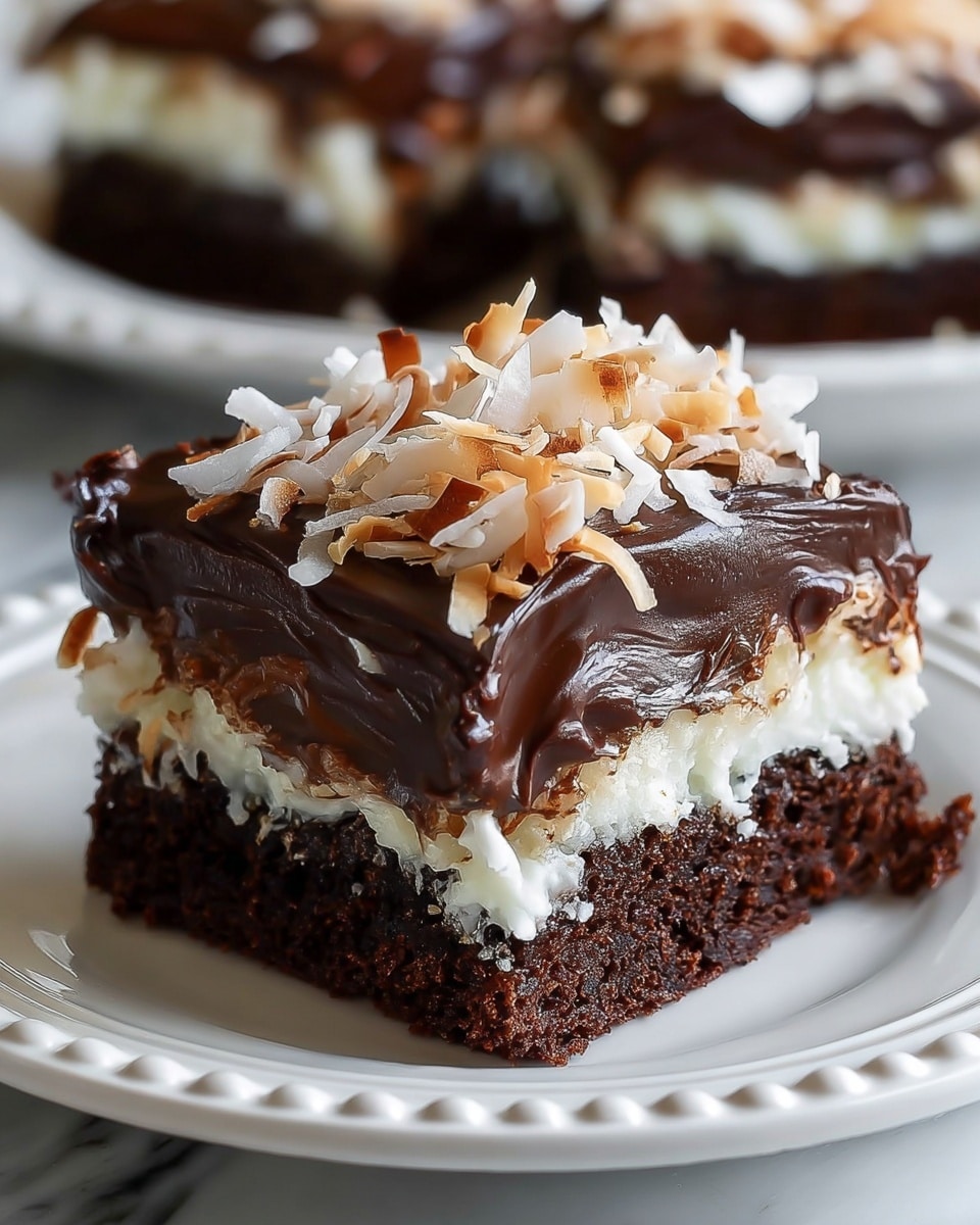 The image shows a close-up of a square chocolate dessert with three visible layers. The bottom layer is a moist, dark chocolate cake. Above it is a thick, creamy white layer that looks soft and fluffy, slightly melting into the cake beneath. The top layer is rich, glossy dark chocolate frosting spread smoothly but with some soft swirls, topped with toasted coconut flakes that have a mix of white and golden-brown shades. The dessert is placed on a white plate with a raised, beaded edge, set against a white marbled texture. In the background, another piece of the same dessert is partially visible. Photo taken with an iphone --ar 4:5 --v 7