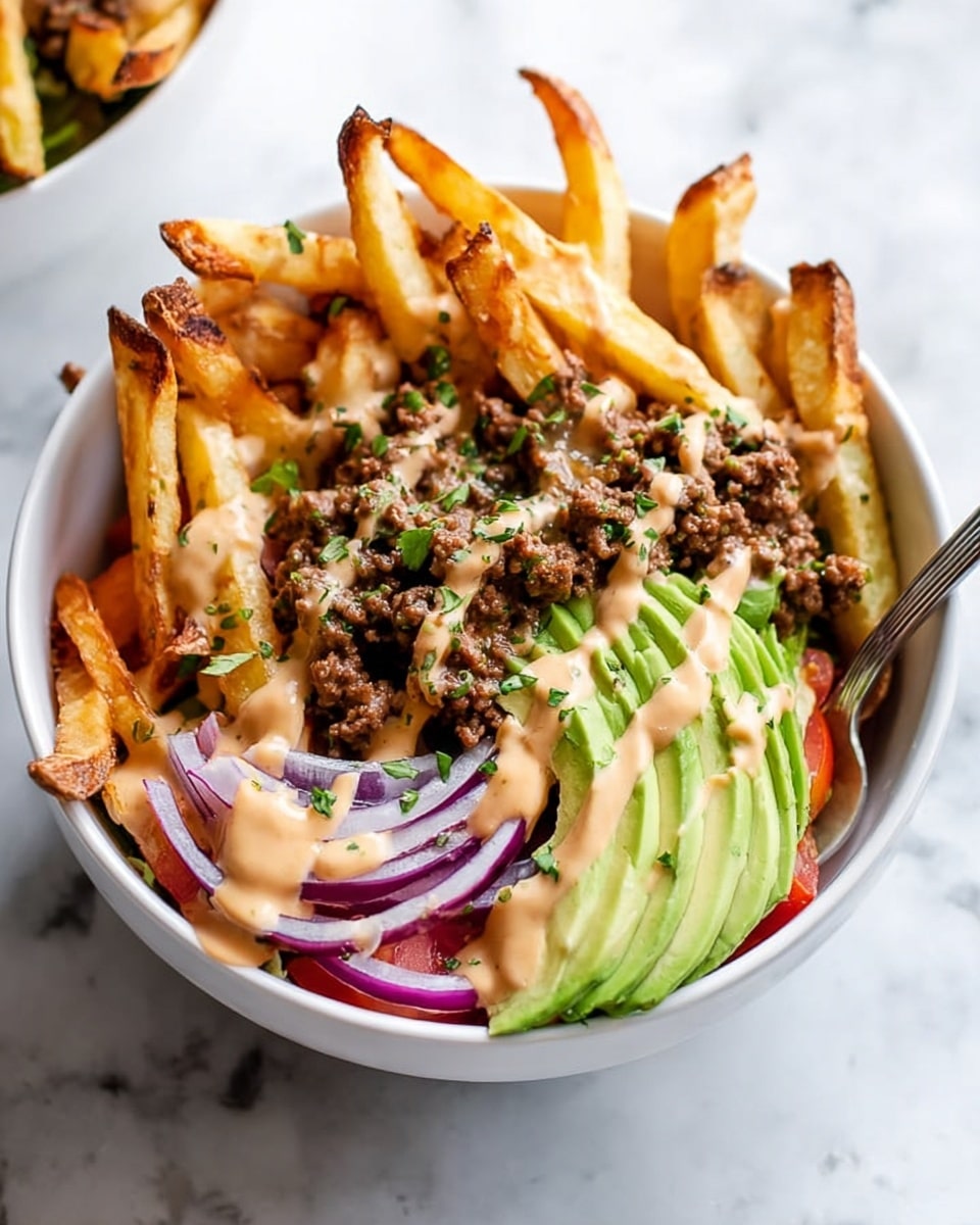The image shows a white bowl filled with layers of food on a white marbled surface. At the top and leaning out of the bowl, there are golden-brown French fries with a crispy texture. Below the fries, there is a layer of browned ground beef. On one side of the bowl, there are thin slices of fresh green avocado arranged neatly, and next to the avocado, purple-red thin slices of onion are visible. At the bottom, there are some pieces of red tomato and green lettuce peeking through. The dish is drizzled with a light brown creamy sauce and sprinkled with small chopped green herbs. A silver spoon is partly inside the bowl. Photo taken with an iphone --ar 4:5 --v 7